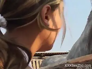 Nude blonde guides huge horse cock into her shaved pussy